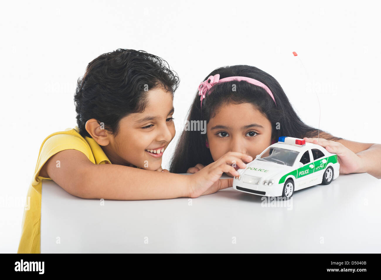 Children playing with a toy car Stock Photo - Alamy