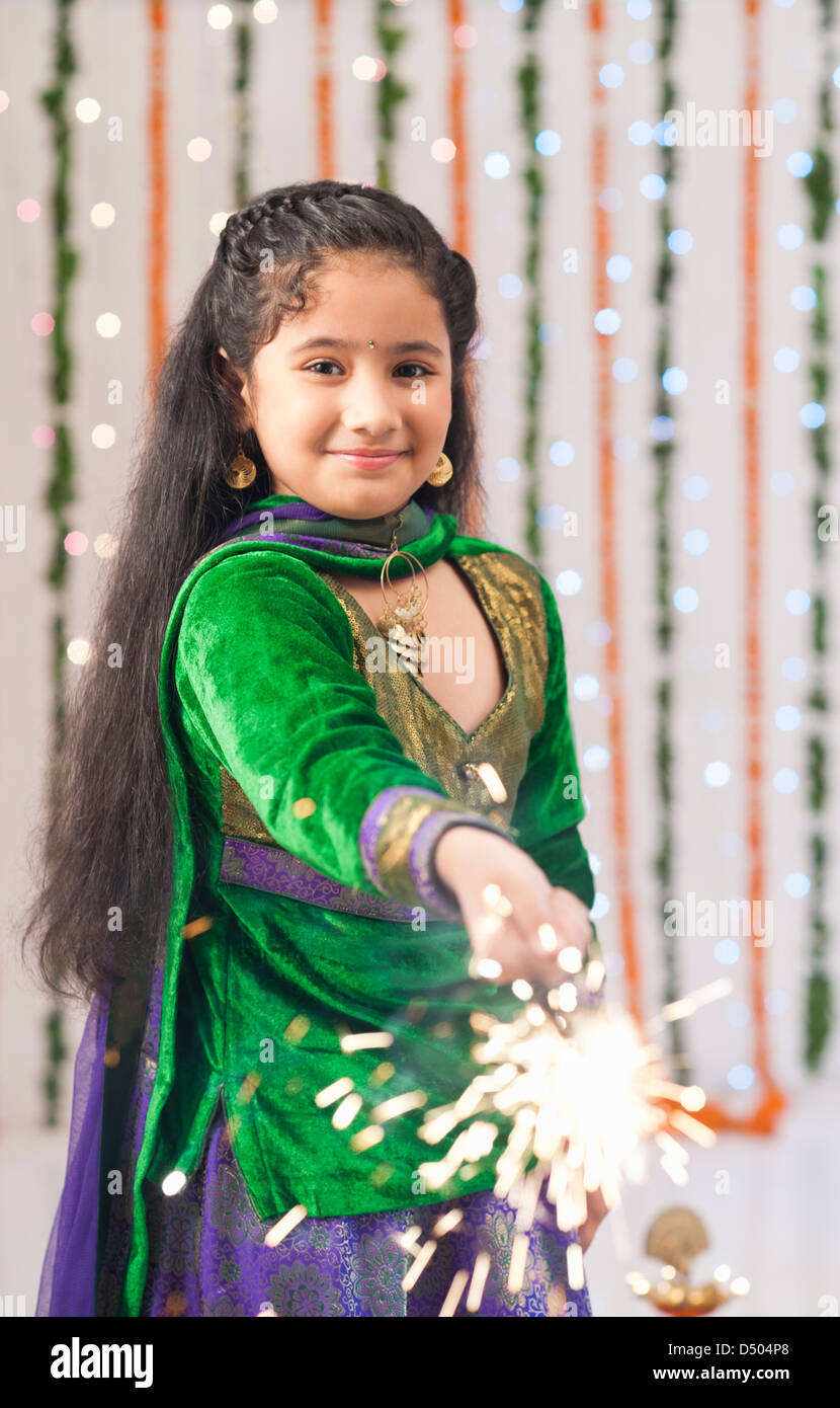 Girl burning fire crackers on Diwali Stock Photo Alamy