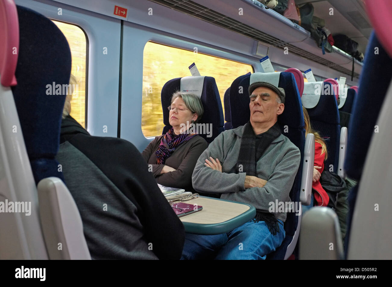 Two people asleep on a UK train Stock Photo