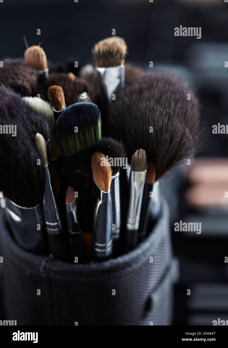 Close-up of makeup brushes in a pot as part of a makeup artist's kit. Stock Photo