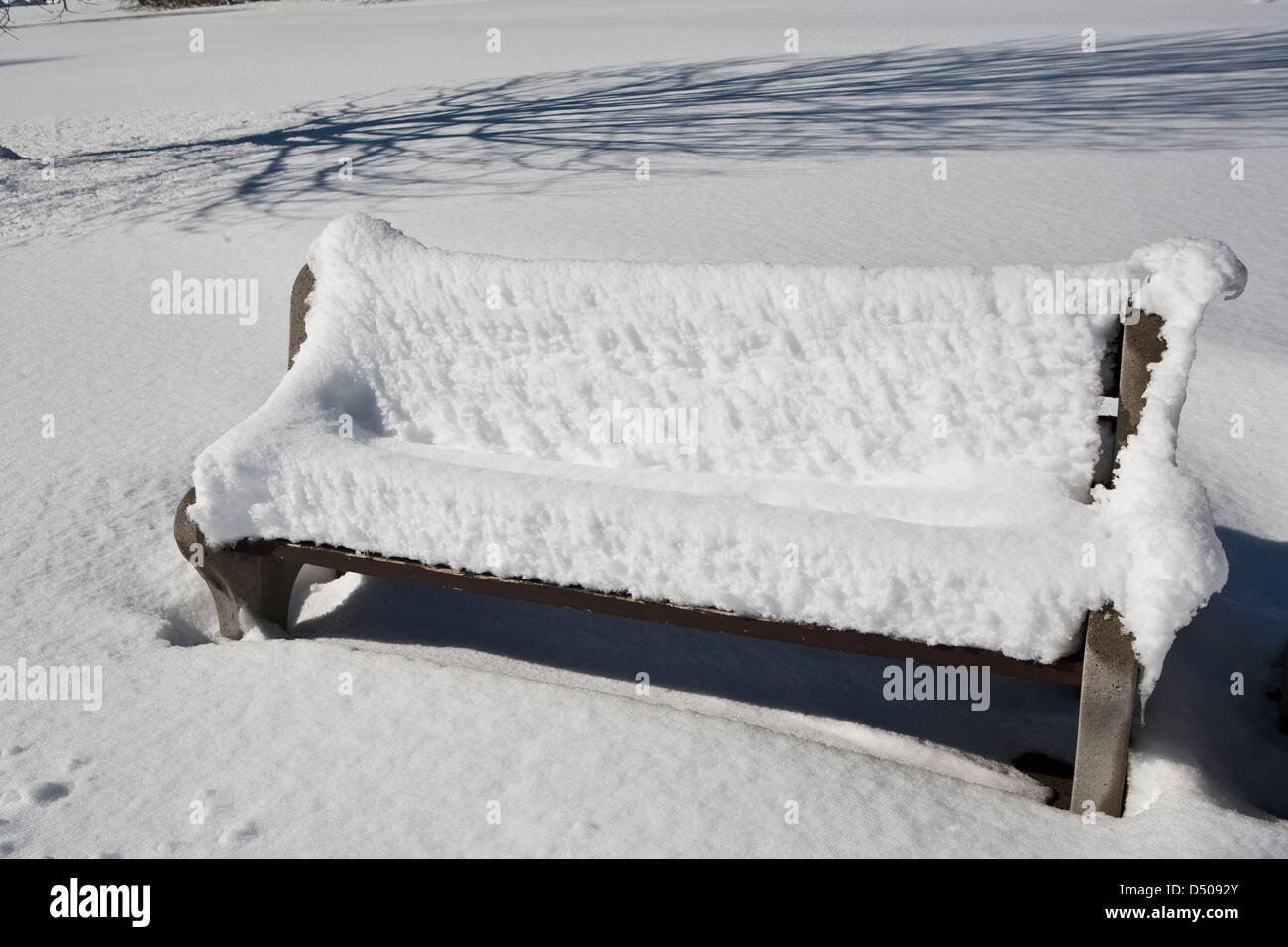 Park bench covered in snow Stock Photo - Alamy