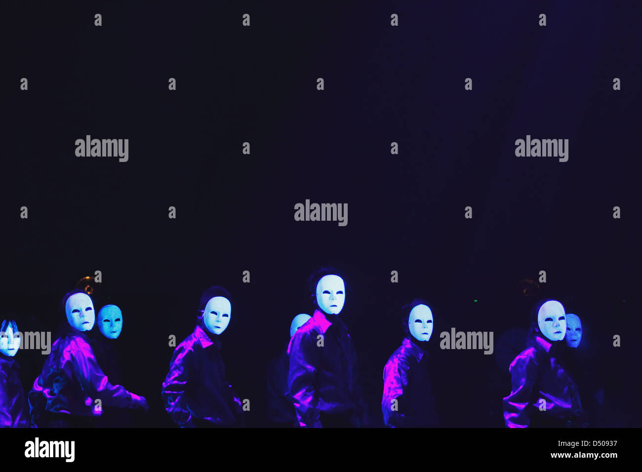 Group of dancers wearing masks Stock Photo