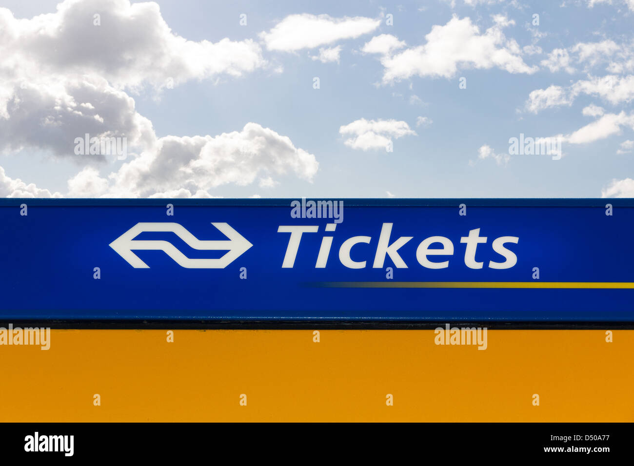 Top side of Dutch train ticket machine with blue sky and clouds Stock Photo