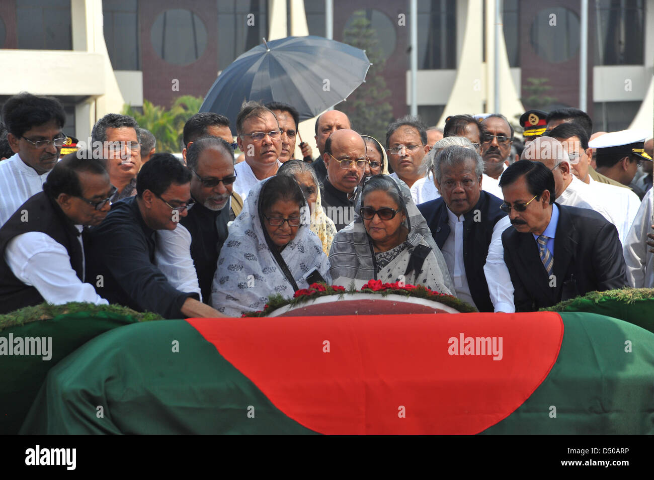Bangladesh's Prime Minister Sheikh Hasina (C) lays a wreath on the coffin of Bangladesh's president Md. Zillur Rahman after the arrival of the coffin from Singapore at the airport in Dhaka, Bangladesh, 21 March 2013. Rahman died 20 March at age 84 in hospital in Singapore, where he had been undergoing treatment for respiratory problems, the presidential palace said. The government declared three days of mourning for Rahman, who had been active in politics for more than six decades. Stock Photo
