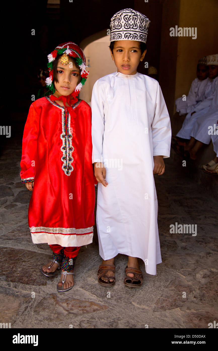 Young Omani school children in Traditional costumes on a school visit the Nizwa Fort in Oman Stock Photo