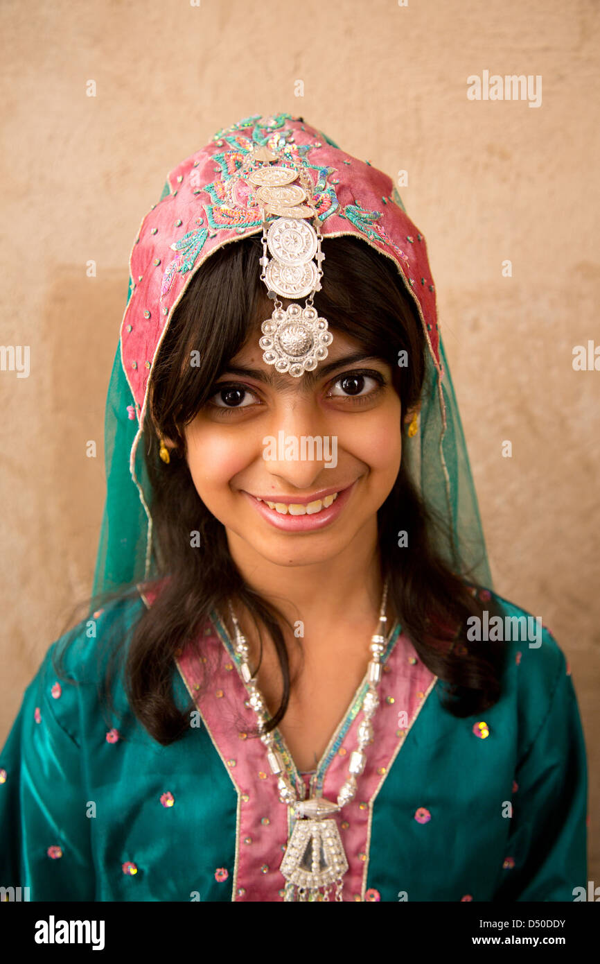 A pretty young Omani girl with Henna Tattoos wearing a traditional costume and headdress Stock Photo