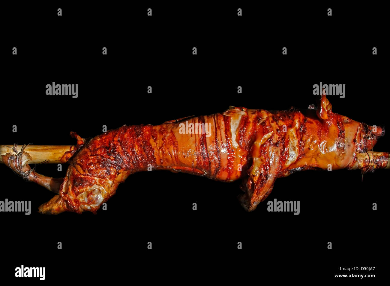 suckling pig on a spit Stock Photo