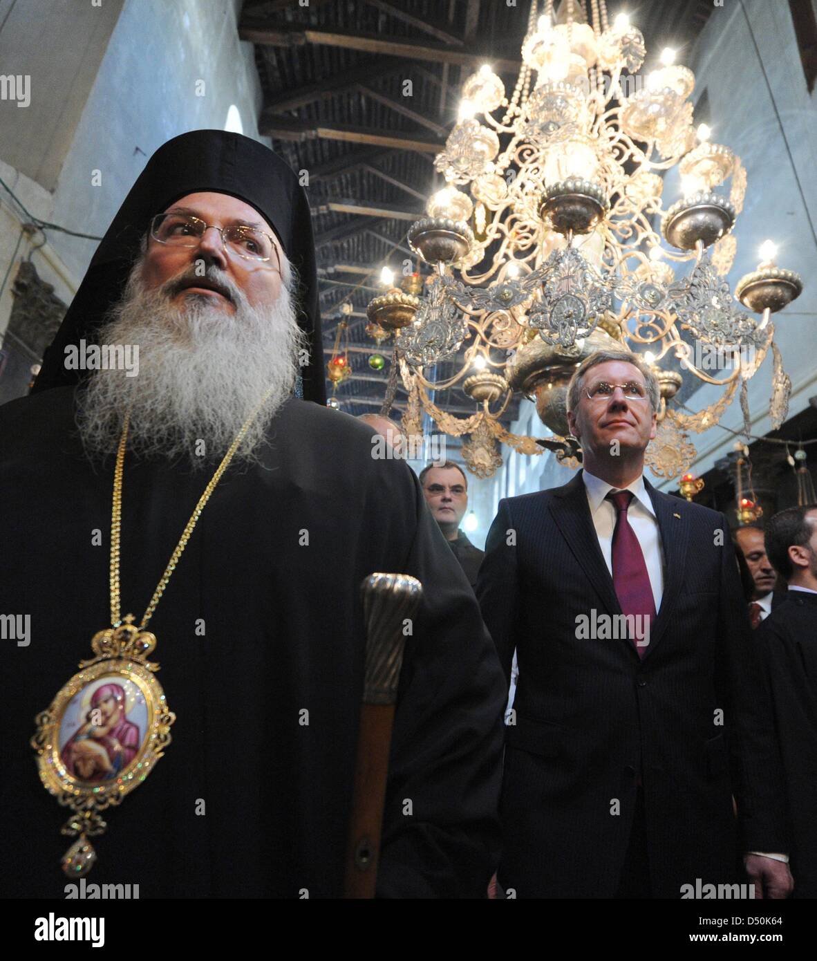 German President Christian Wulff (R) and his daughter Annalena (not pictured) walk through the Church of the Nativity together with Greek-Orthodox bishop Theoflakes (L) in Bethlehem, Palestinian Territories, 30 November 2010. The four-day state visit of German President Wulff will end today with his visit to the Palestinian Territories. Photo: RAINER JENSEN Stock Photo