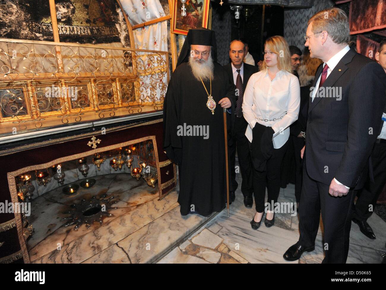 German President Christian Wulff (R) and his daughter Annalena walk through the Church of the Nativity together with Greek-Orthodox bishop Theoflakes (L) in Bethlehem, Palestinian Territories, 30 November 2010. The four-day state visit of German President Wulff will end today with his visit to the Palestinian Territories. Photo: RAINER JENSEN Stock Photo