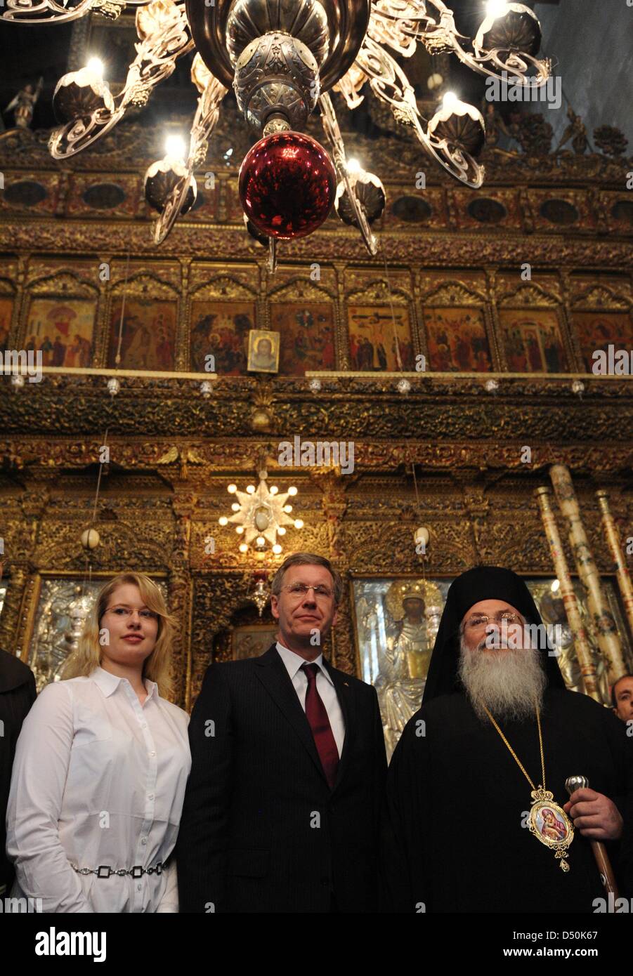 German President Christian Wulff (M), his daughter Annalena and Greek-Orthodox Bishop Theoflakes walk through the Church of the Nativity in Bethlehem, Palestinian Territories, 30 November 2010. The four-day state visit of German President Wulff will end today with his visit to the Palestinian Territories. Photo: RAINER JENSEN Stock Photo