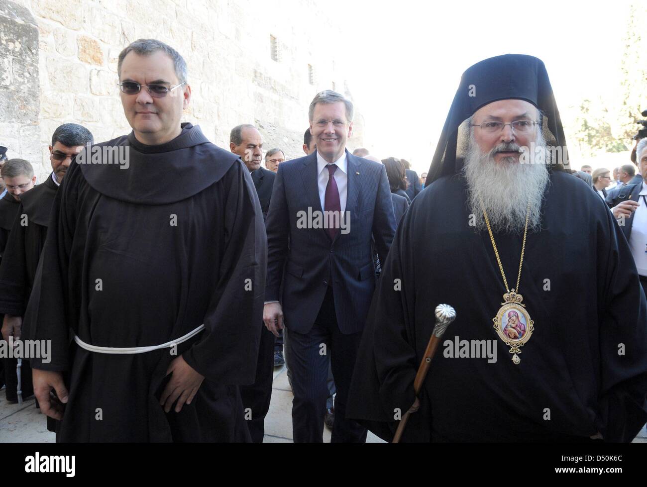 German President Christian Wulff (M), his daughter Annalena (not pictured), Greek-Orthodox Bishop Theoflakes (R) and the head of the Franciscan parish Father Marwan Daadas (L) walk to the Church of the Nativity in Bethlehem, Palestinian Territories, 30 November 2010. The four-day state visit of German President Wulff will end today with his visit to the Palestinian Territories. Pho Stock Photo
