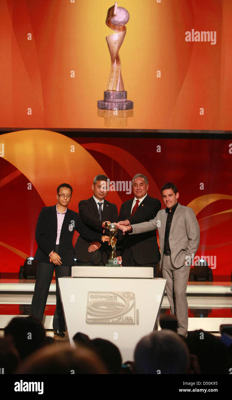 The coaches from the B-group of England, Hope Powell (L-R), Japan, Norio Sasaki, Mexico, Leonardo Cuellar and of New Zealand, John Herdman, pose with the cup after the drawing for the FIFA Women's World Cup 2011 in Frankfurt, Germany, 29 November 2010. The FIFA Women's World Cup takes place from 26 June until 17 July 2011 in Germany. Photo: Frank Rumpenhorst Stock Photo