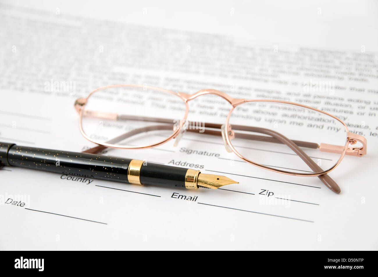 Eyeglasses and pen lay on the document Stock Photo