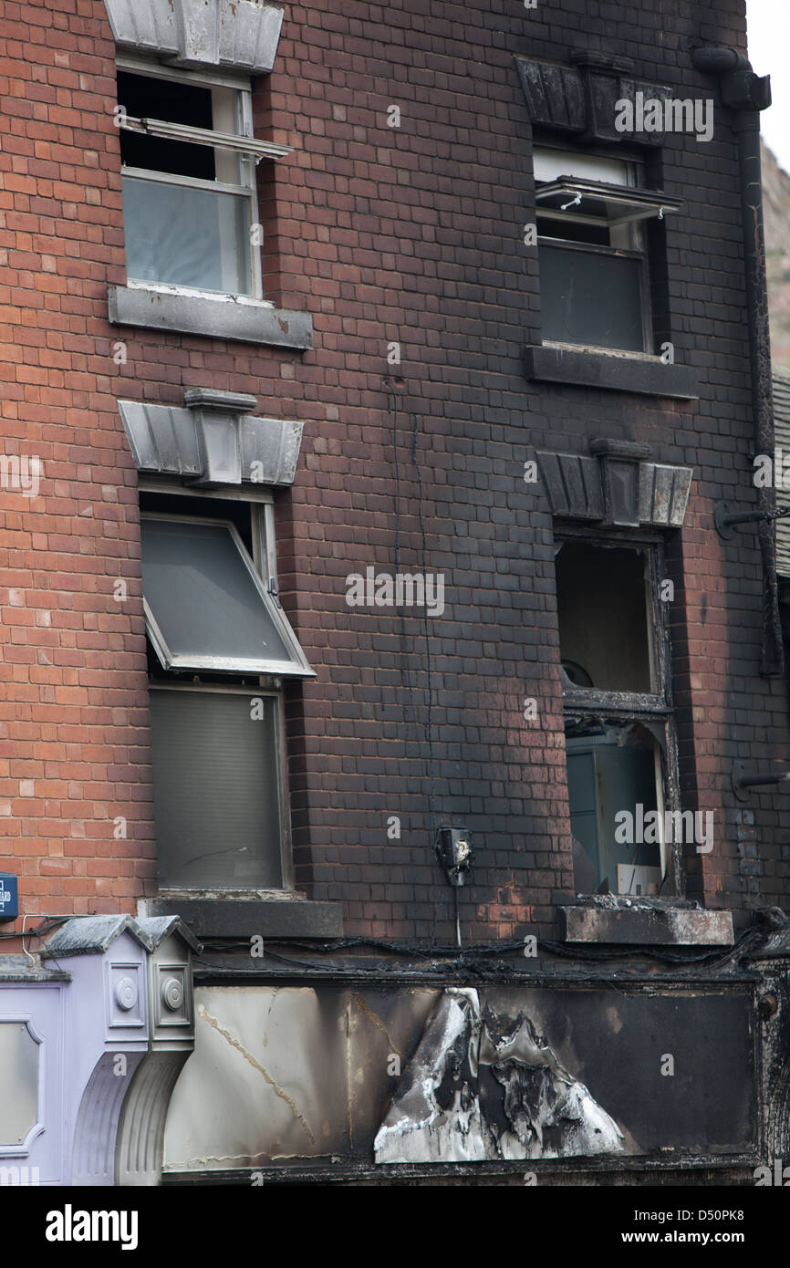 A fire blackened building after a severe fire. Window shattered by the