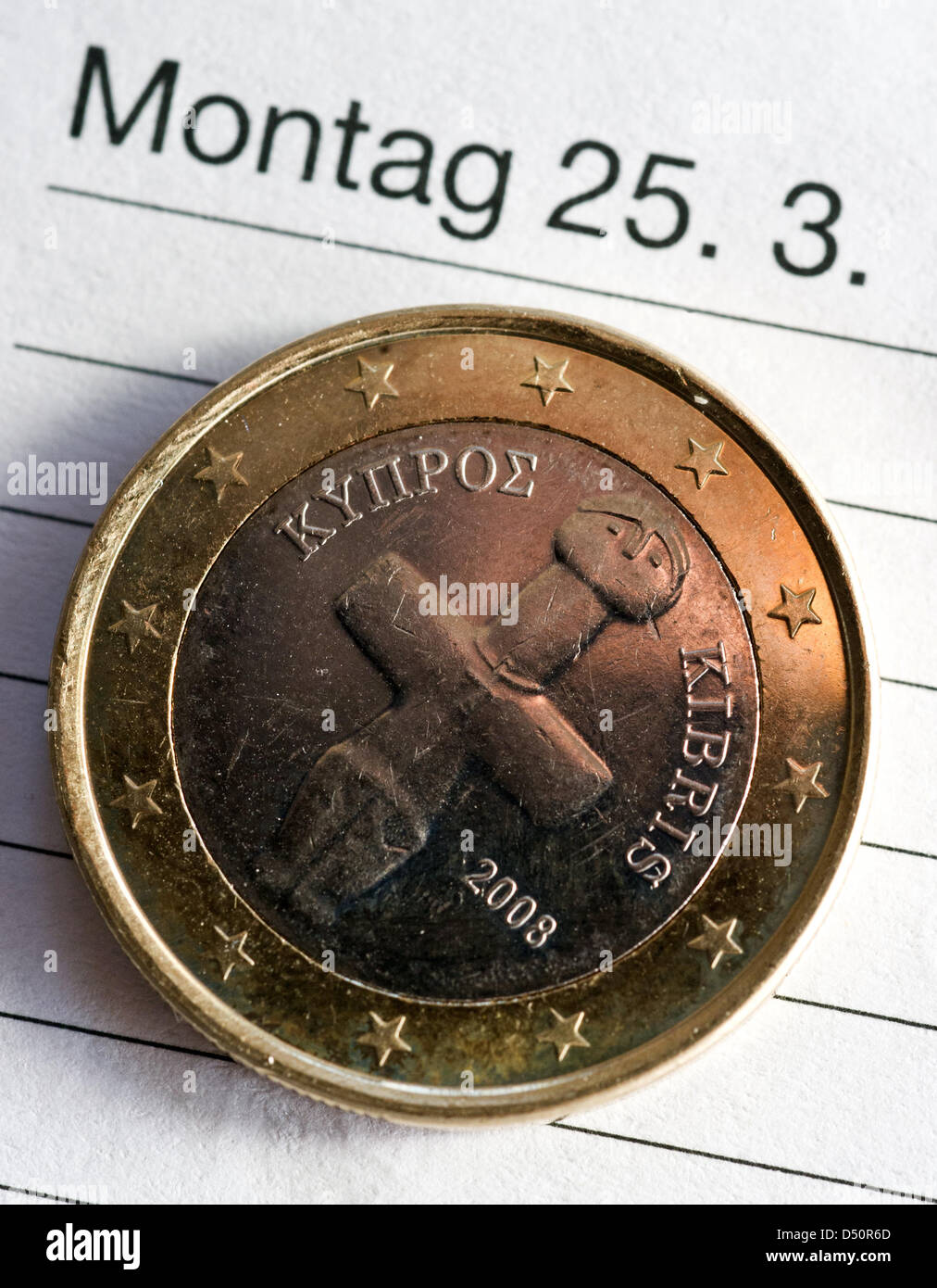 (ILLUSTRATION) An illustration dated 21 March 2013 shows a Cypriot 10 cents euro coin sitting on a calender next to the date Mondy, 25 March in Frankfurt Oder, Germany. After months of struggles, the EU has secured an aid package for Cyprus. The European Central bank has garanteed its financial package to Cyprus, but only until next Monday, according to the ECB in Frankfurt Main on Thursday. Photo: PATRICK PLUEL Stock Photo
