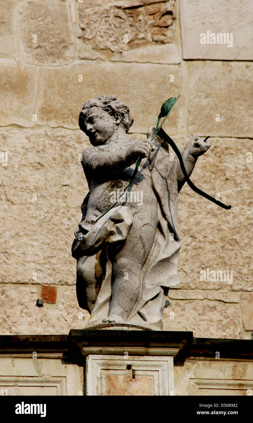 Cupid with bow and arrows. Sculpture. Facade of the Duomo in Cremona. Italy. Stock Photo