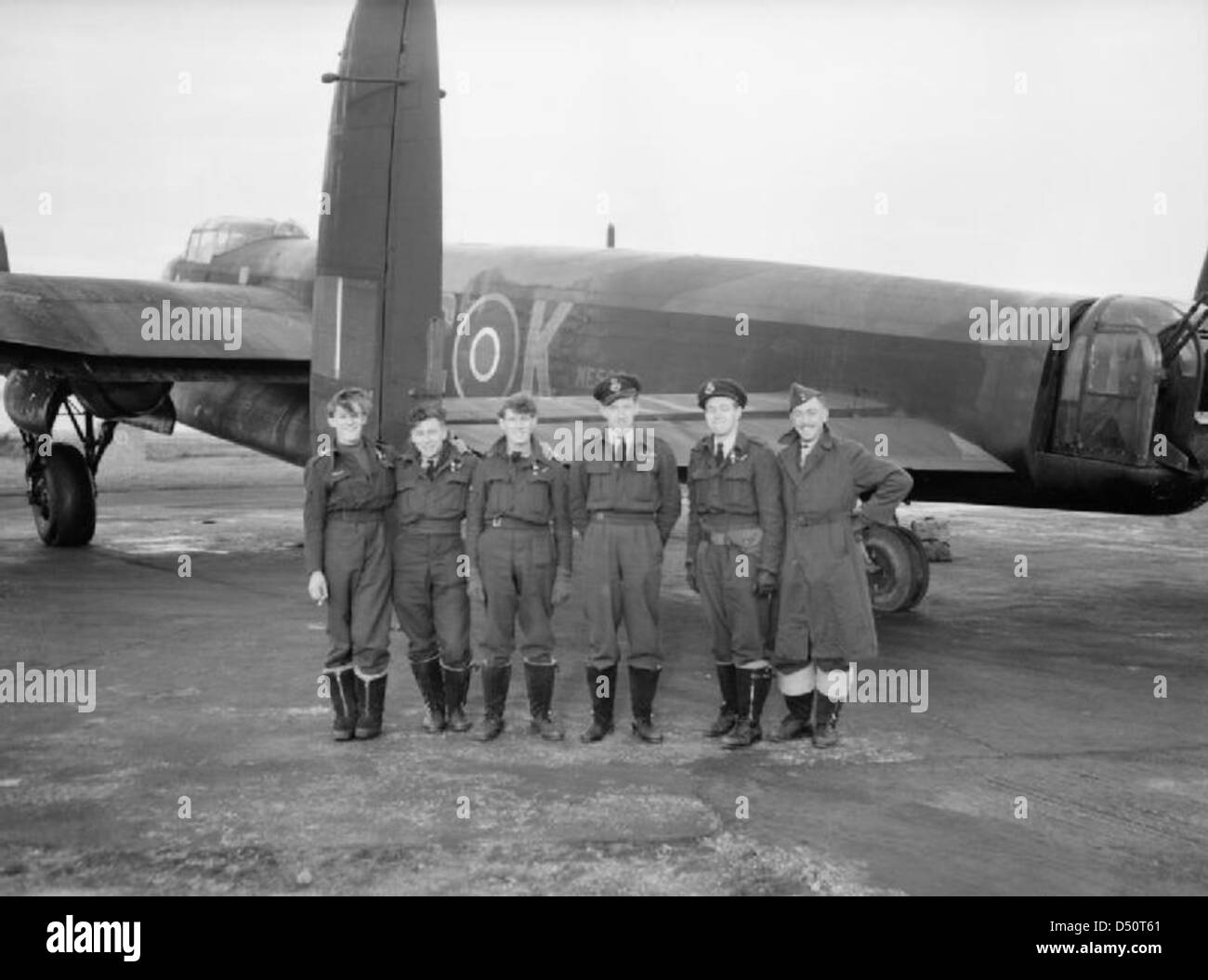 Flying Officer J Sanders DFC (third from right), and his cheerful crew of No 617 Squadron with their Lancaster, ME562/KC-K, following the successful daylight operation against the Tirpitz in Tromso Fjord in Norway on 12 November 1944. Stock Photo