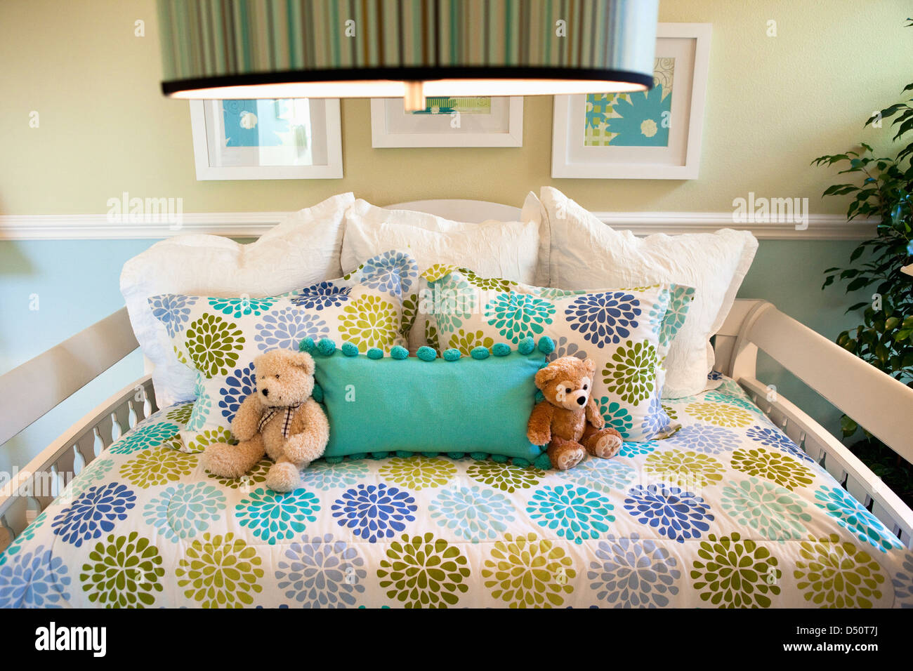 Teddy bears and pillows arranged on day bed, Tustin, California, USA Stock Photo