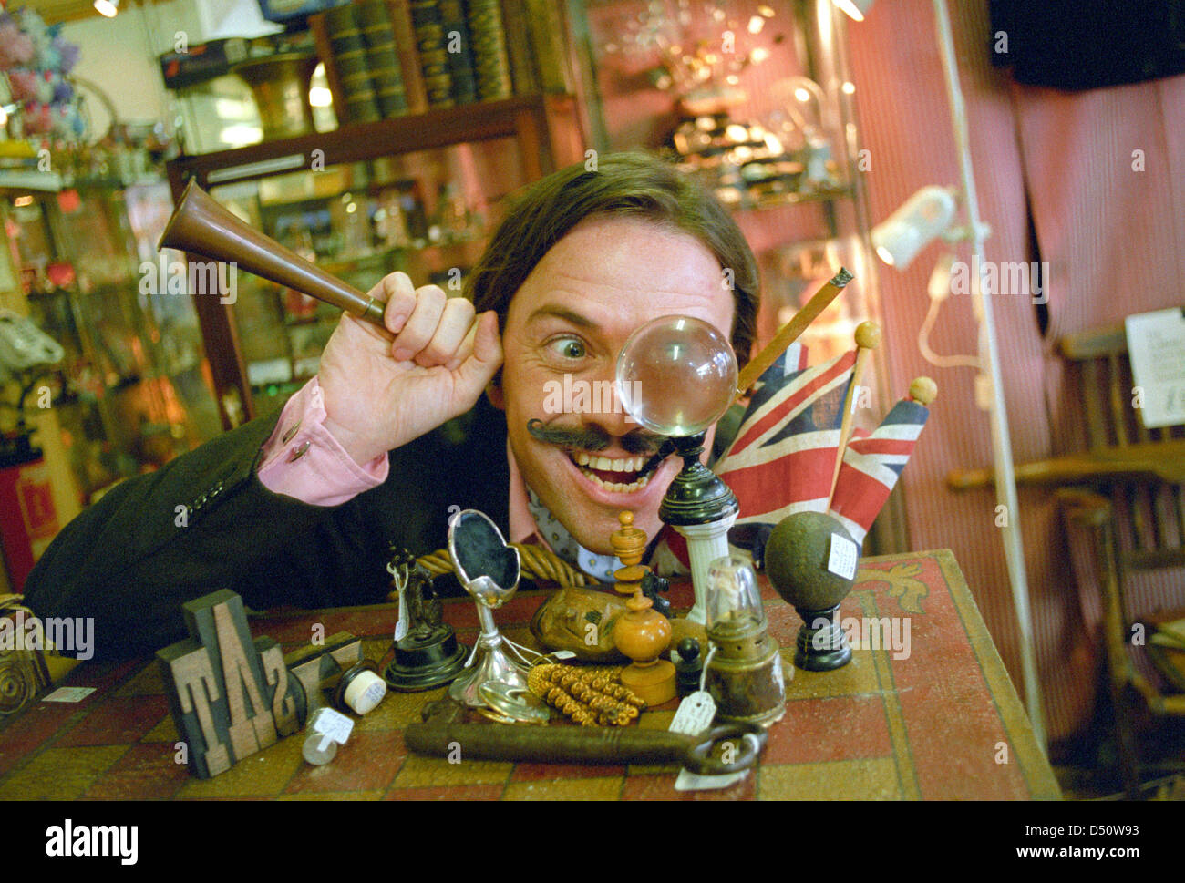 An eccentric Brit in his shop of curiosities Stock Photo
