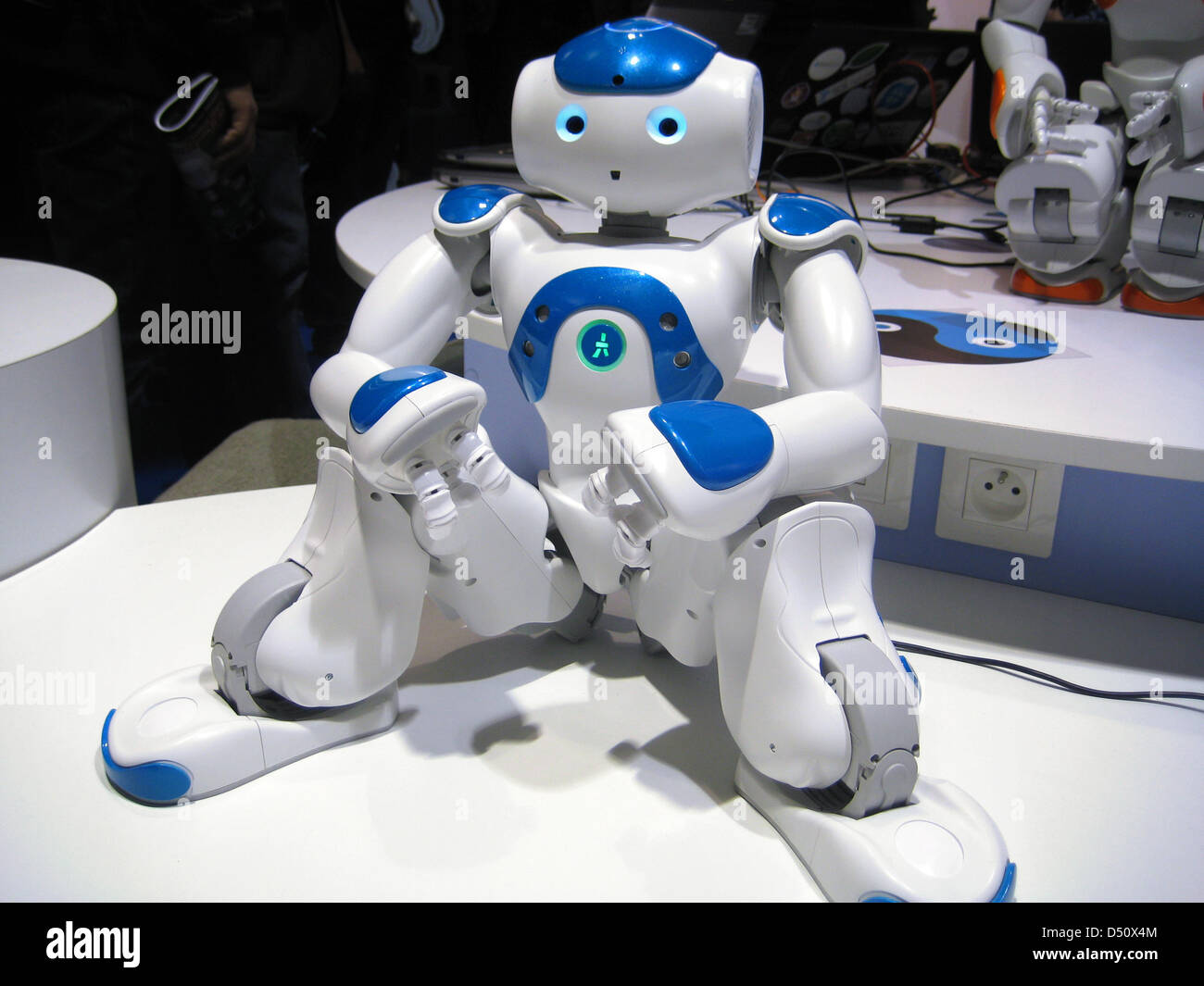The humanoid robot 'Nao' built by Aldebaran Robotics sits on a table at the Innorobo expo in Lyon, France, 20 March 2013. Researchers and manufacturers are presenting their newest products in the robot industry at Innorobo in Lyon. Photo: Gerd Roth Stock Photo