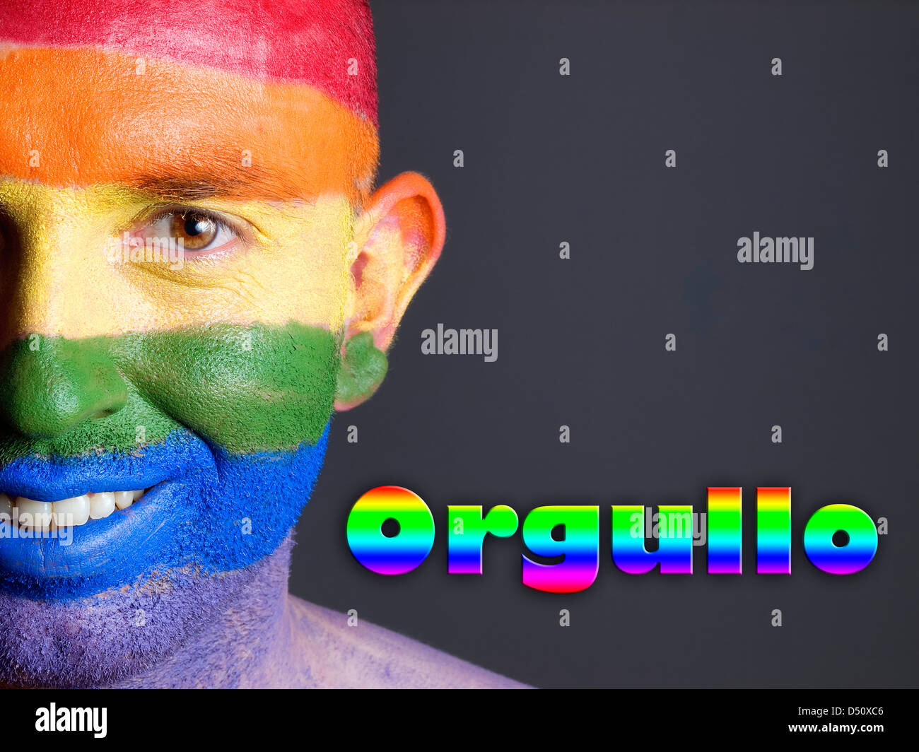 Hombre con la bandera gay pintada en la cara y sonriendo. La palabra 'orgullo' esta escrita en un lado. Stock Photo