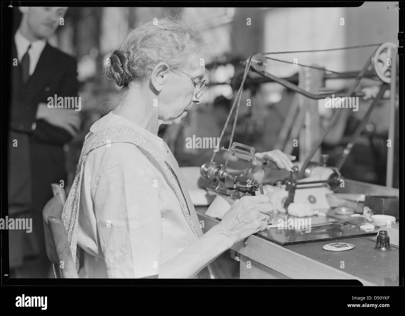 Hamilton Watch. Operation - polishing machine - machine is called wig-wag machine and is used to polish pivots and staff shoulders - semi-skilled operation, 1936 Stock Photo