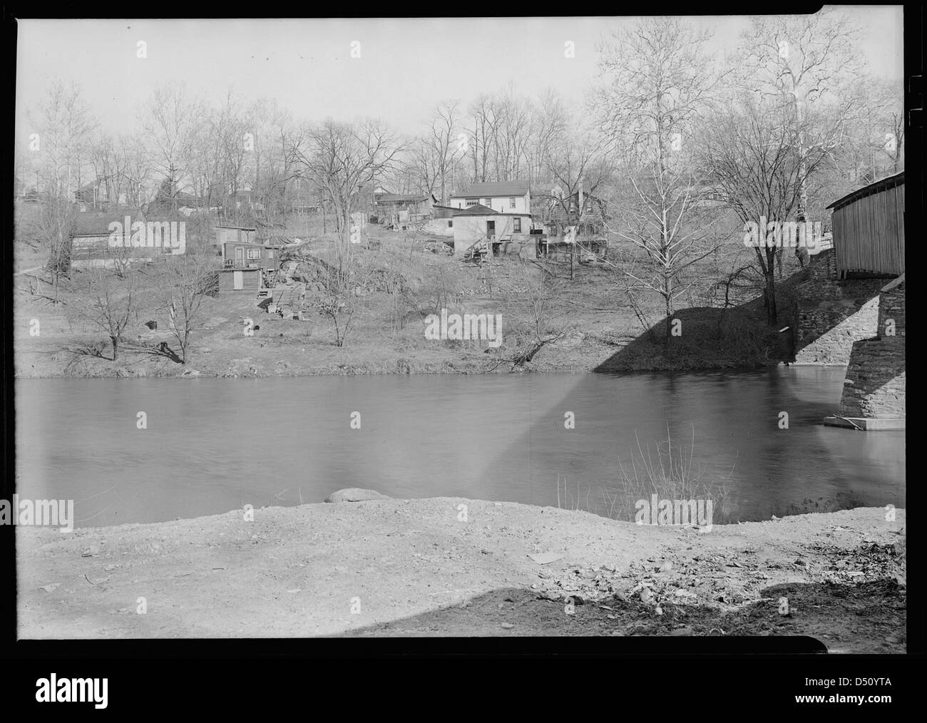 Sunnyside - near covered bridge over Conestoga Creek - dump on one side - shacks on opposite bank - miscellaneous low-paid workers, 1936 Stock Photo