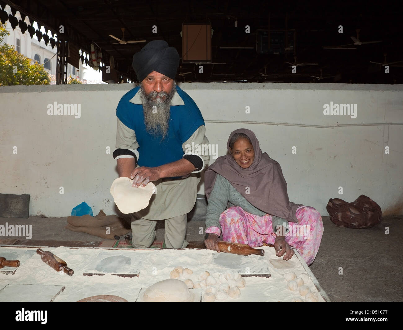 Sikh volunteers making chapattis inside the Golden Temple complex Amritsar Punjab India Stock Photo