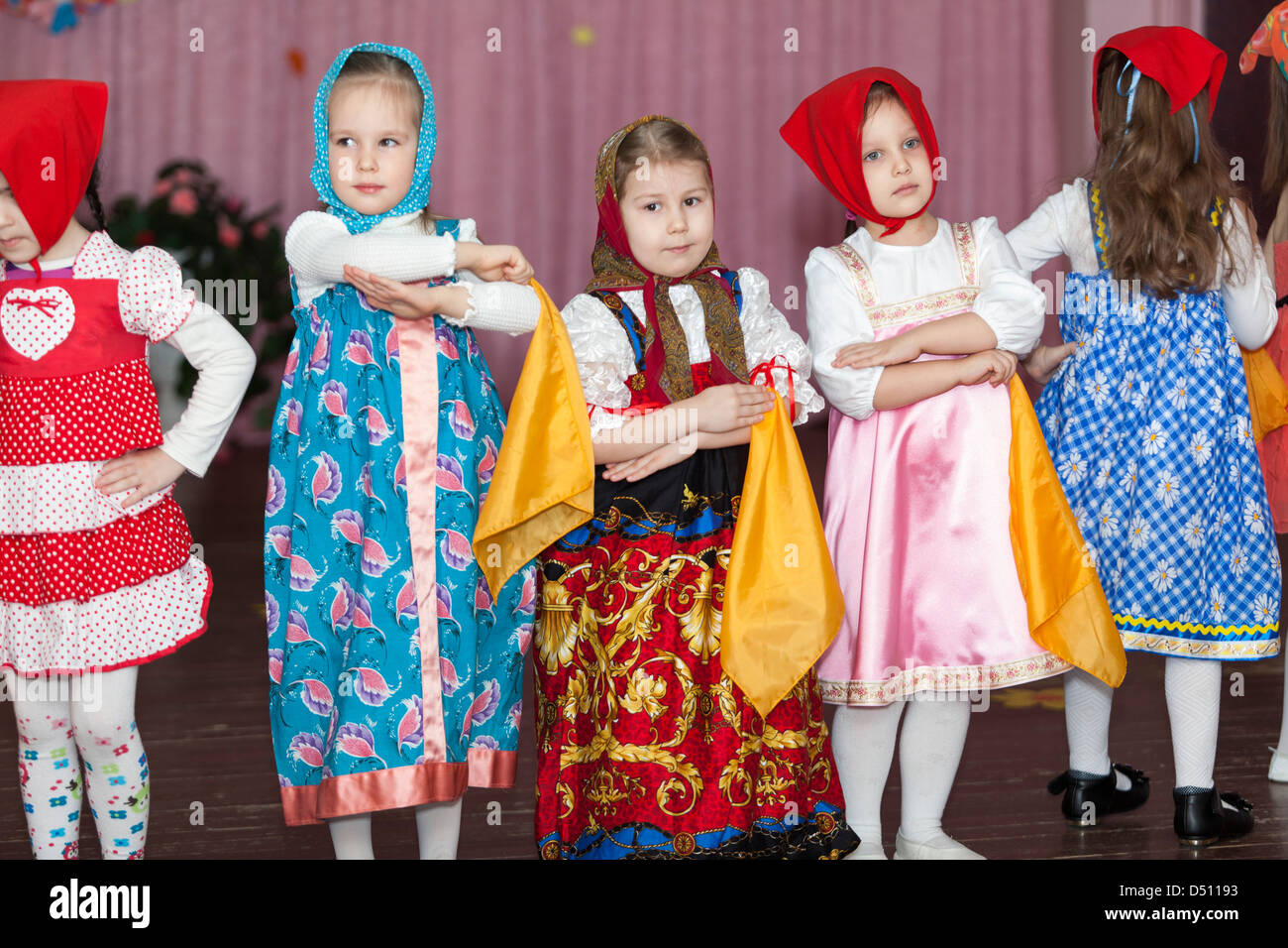 Preschooler girls dancing on the stage in Russian traditional clothes ...