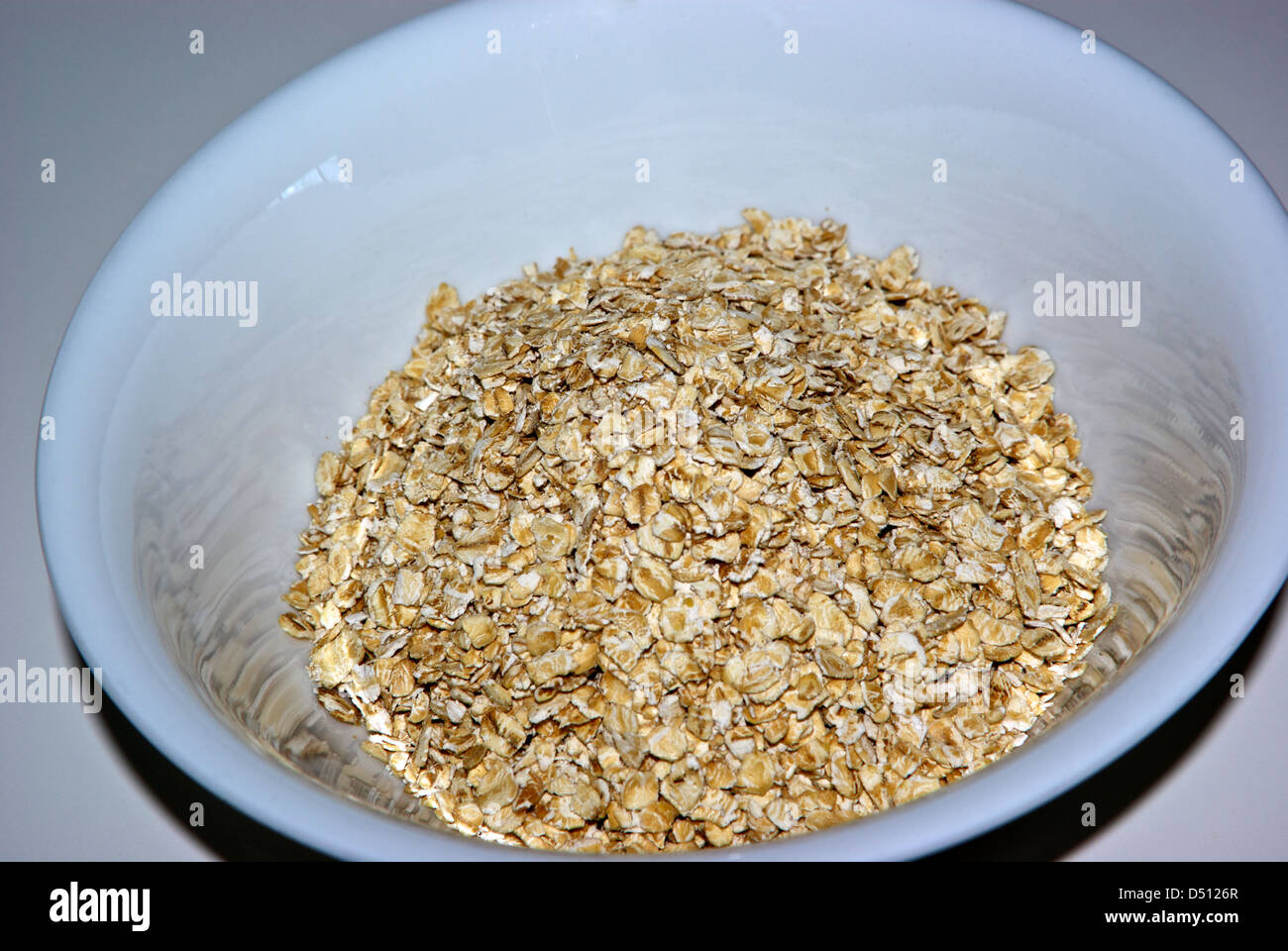 Uncooked bowl whole grain oatmeal high fiber cereal no sodium cholesterol fat Stock Photo Alamy