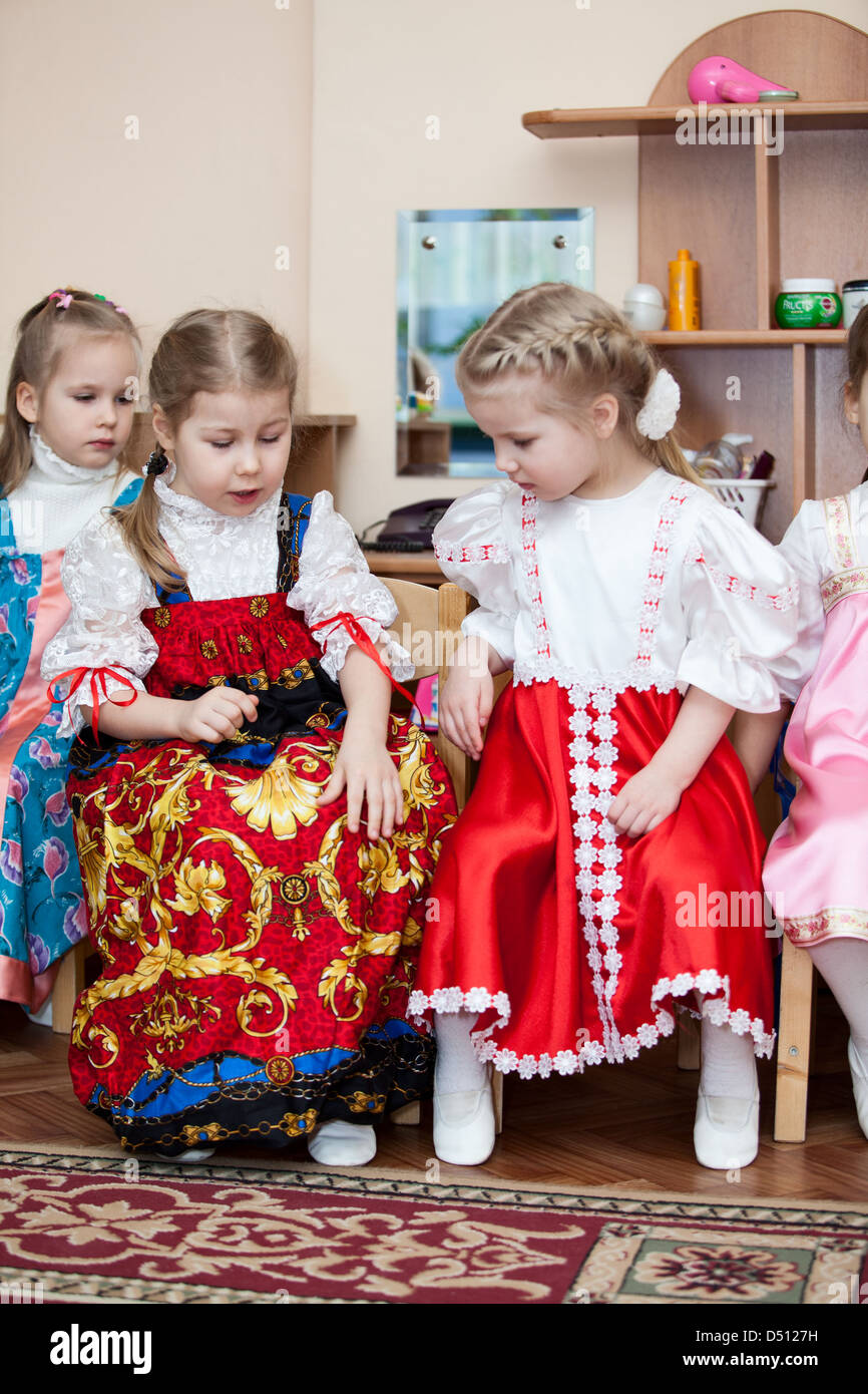 Cute girls in Russian traditional clothes in kindergarten sitting on ...