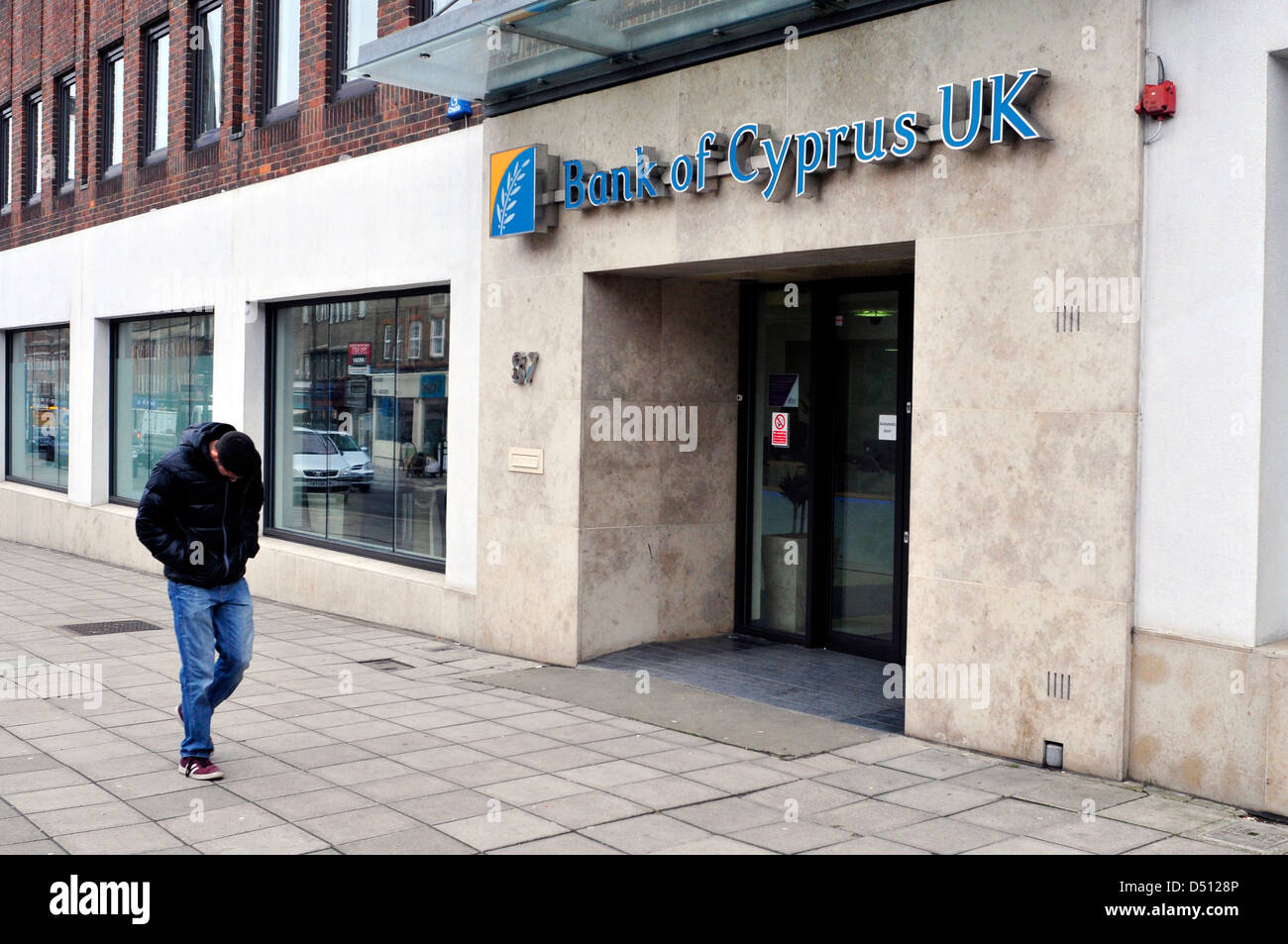 A man walks past Bank of Cyprus in London, United Kingdom Stock Photo
