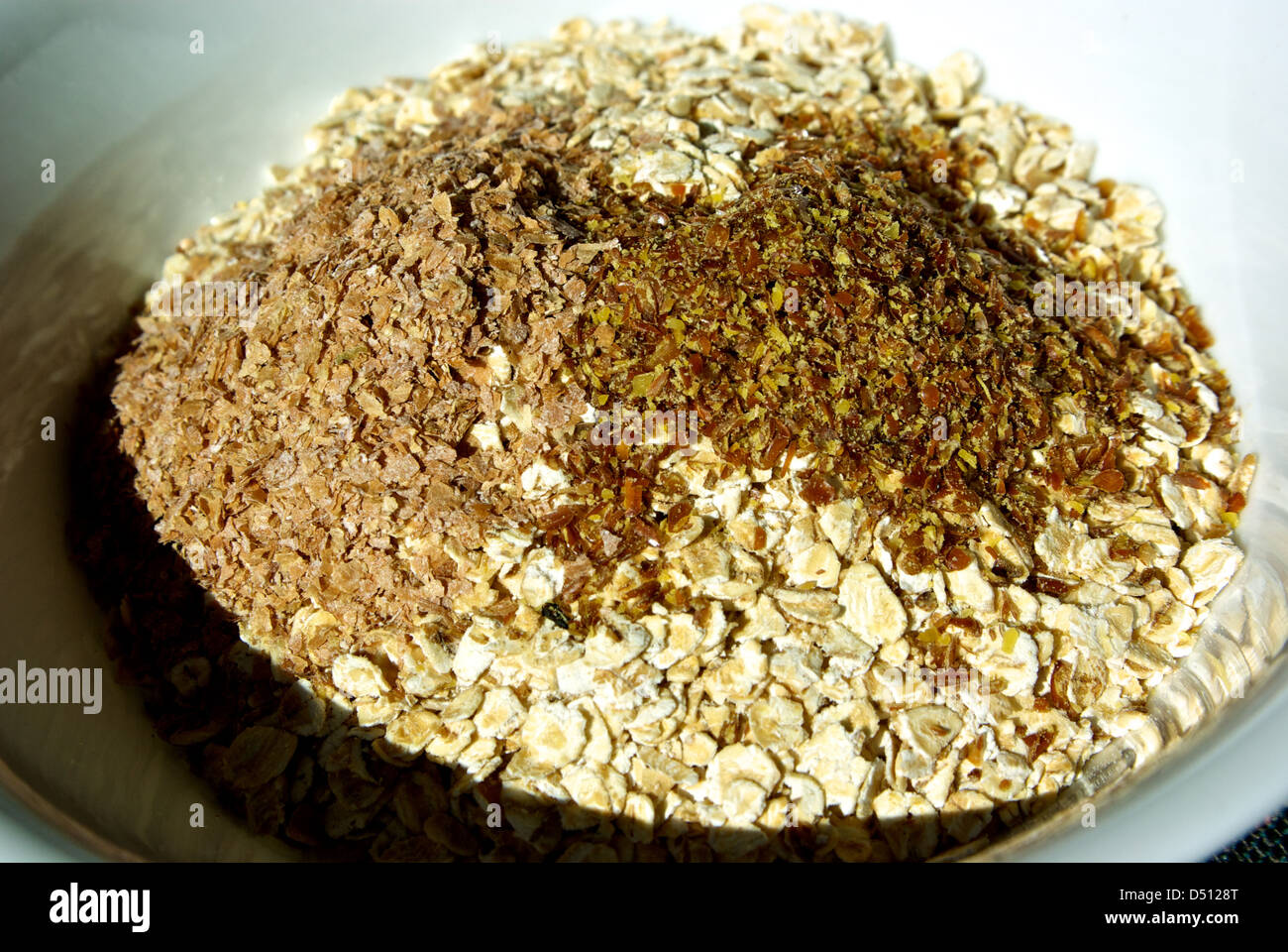 Uncooked bowl of whole grain oatmeal high fiber cereal no sodium