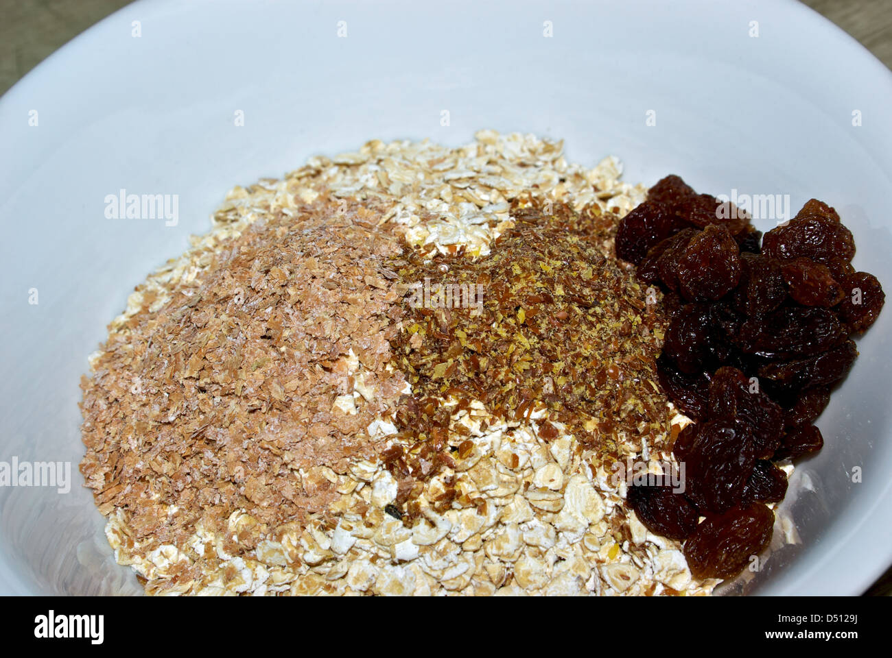 Uncooked bowl whole grain oatmeal high fiber cereal wheat bran ground