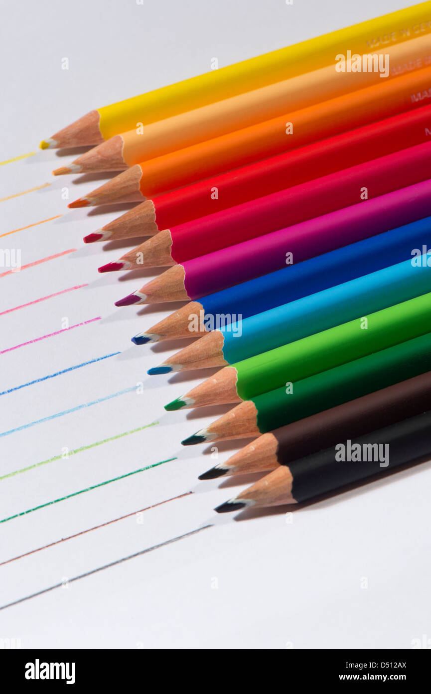 Close-up detail of sharp colourful pencil crayons laid side by