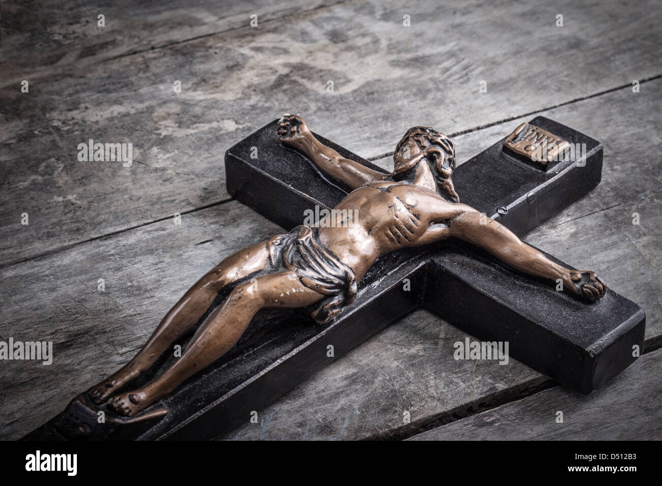 Crucifix on old wooden tablel, retro close up Stock Photo