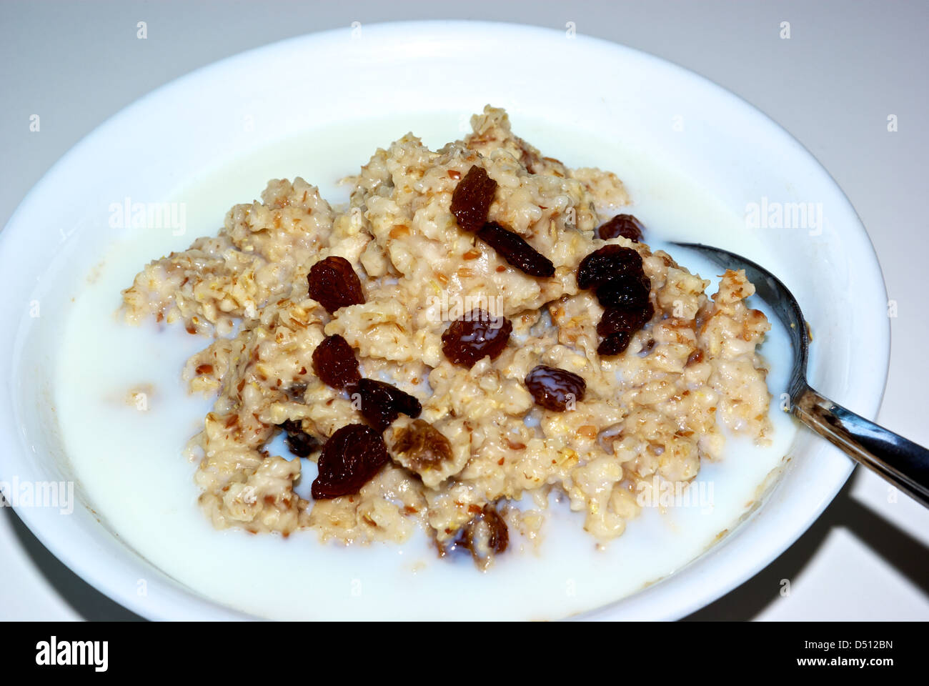 Bowl cooked whole grain oatmeal cereal skim milk Sultana raisins