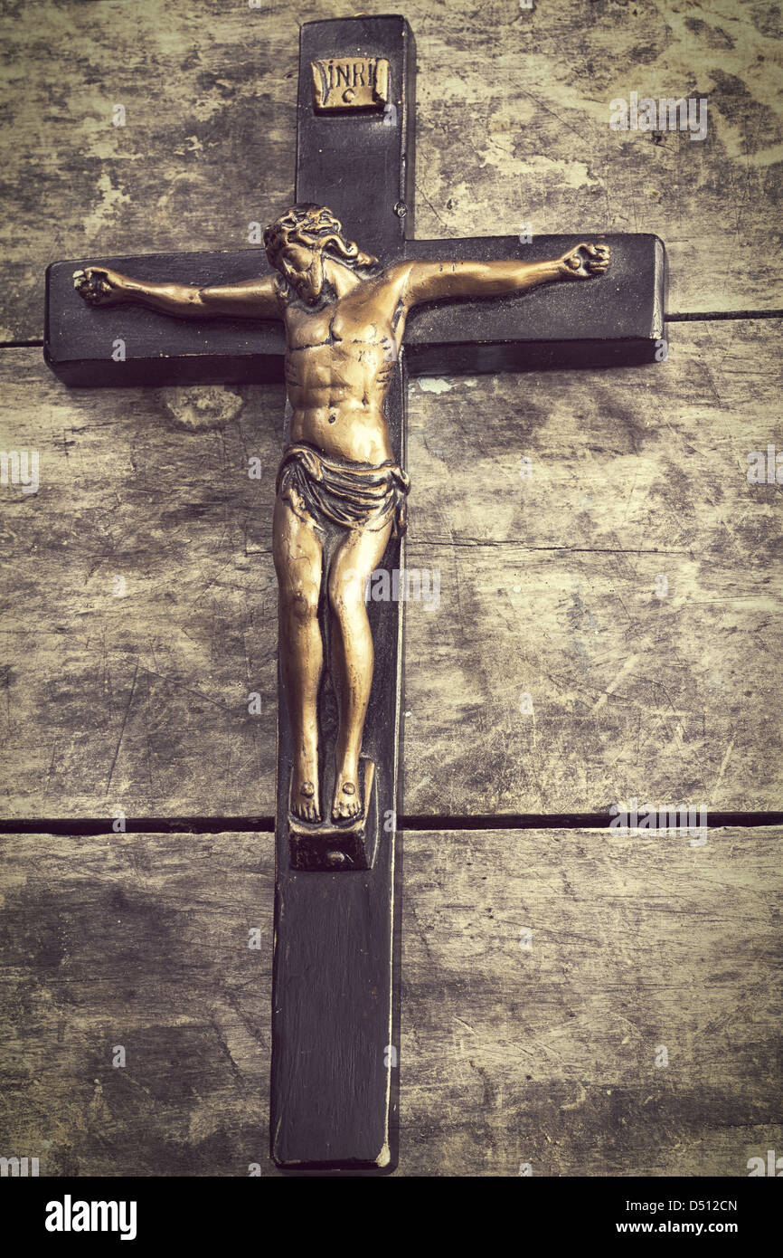 Crucifix on old wooden wall, retro close up Stock Photo