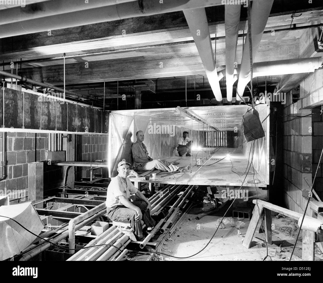 Workers inside Ductwork during the Renovation of the White House, 07/19/1951 Stock Photo