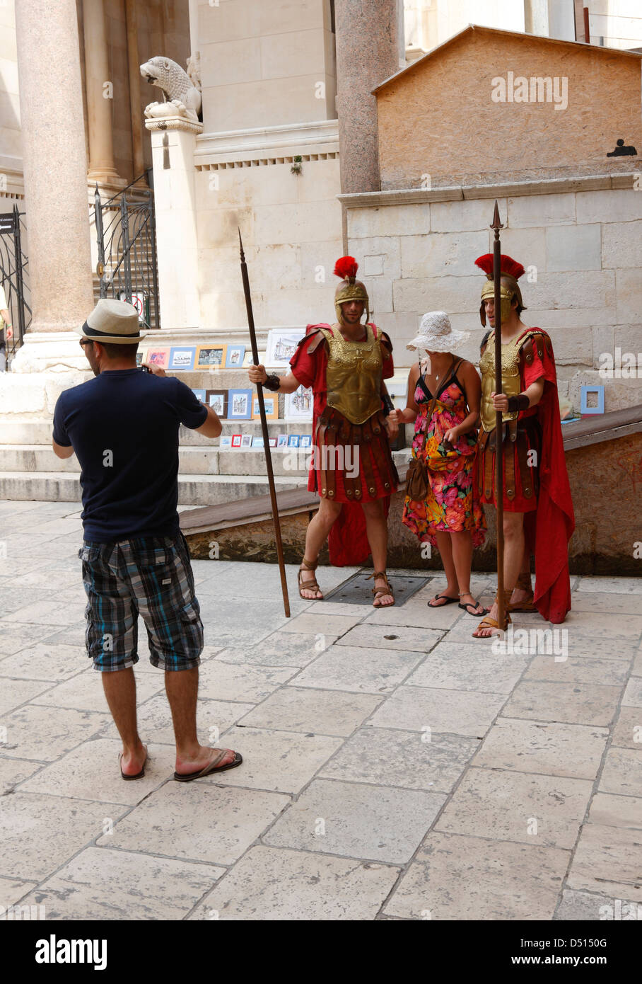 Tourists taking photos with Roman soldiers in Split town Stock Photo
