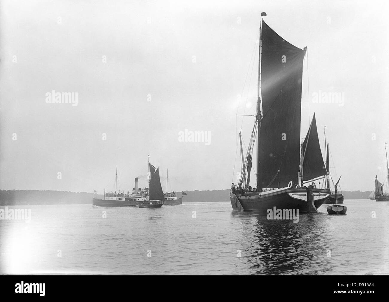 A view across the River Orwell from near Pin Mill with the spritsail barge 'Freston Tower' in the foreground Stock Photo