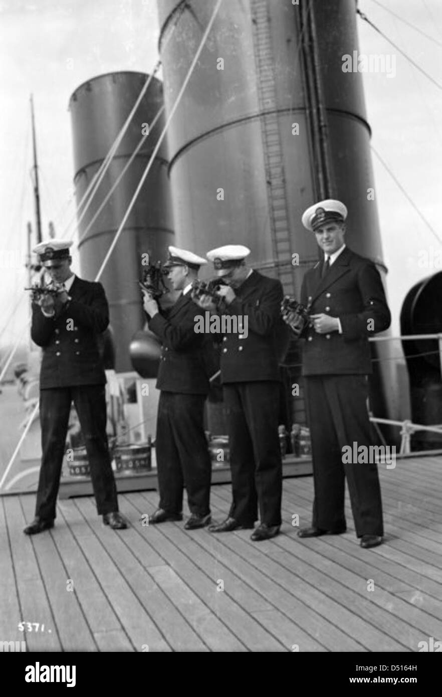 Four P & O cadets of the 'Viceroy of India' on the starboard side of the Bridge Deck with their sextants Stock Photo
