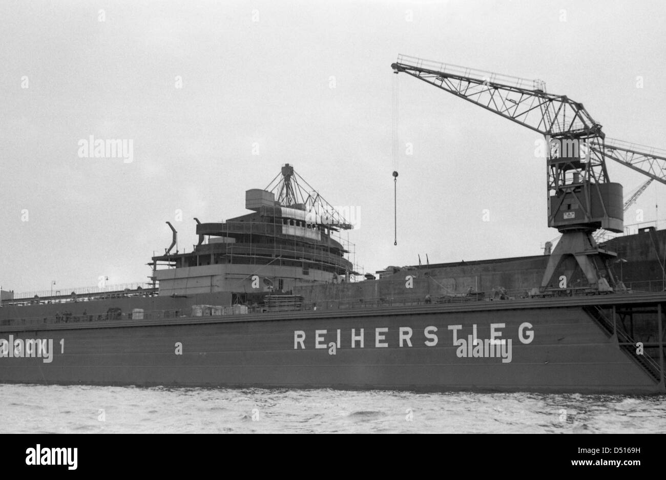 Hamburg, Germany, looking at a dock at Reiherstieg with loading crane in port Stock Photo