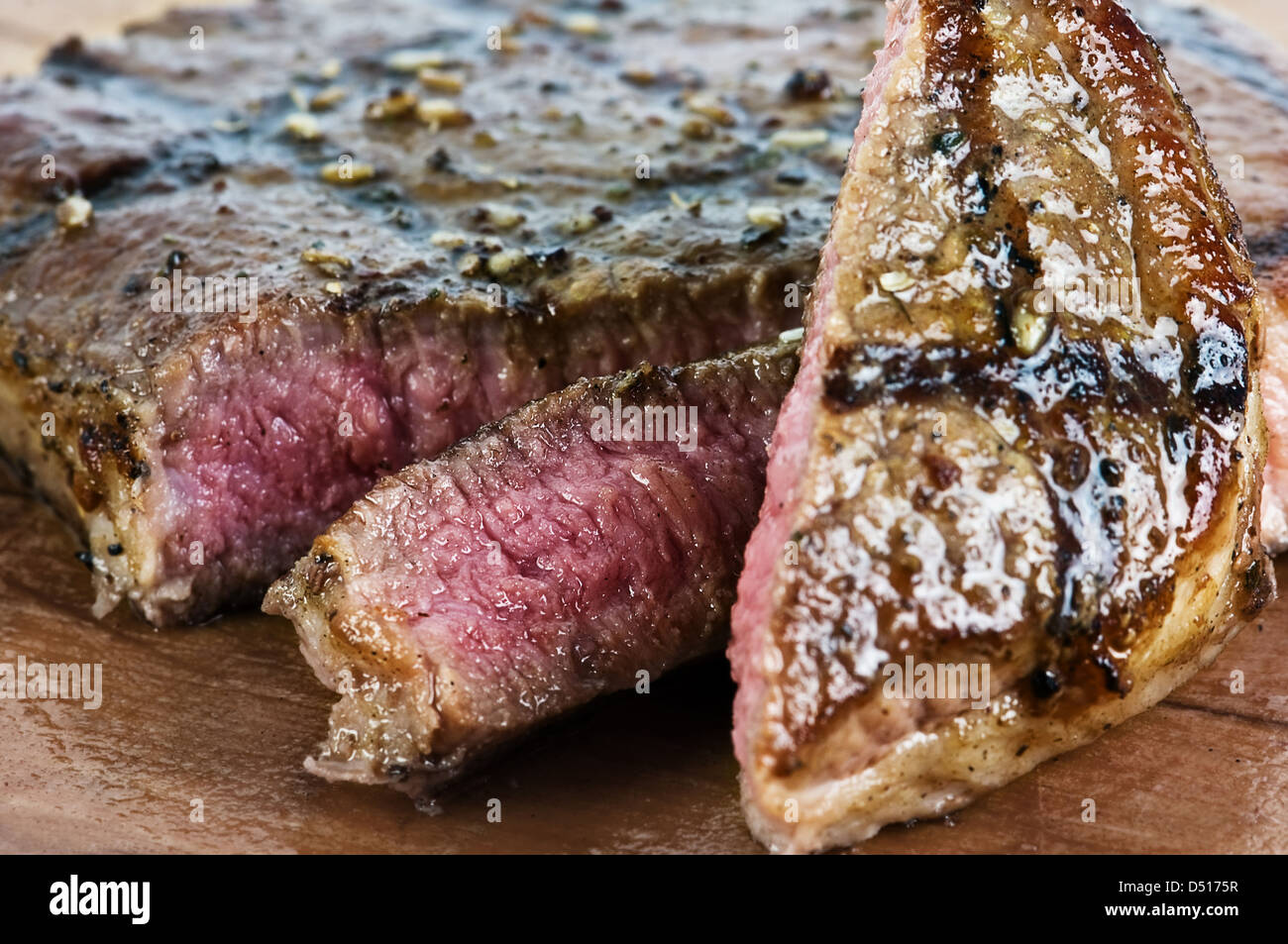 juicy striped steak on wood table Stock Photo