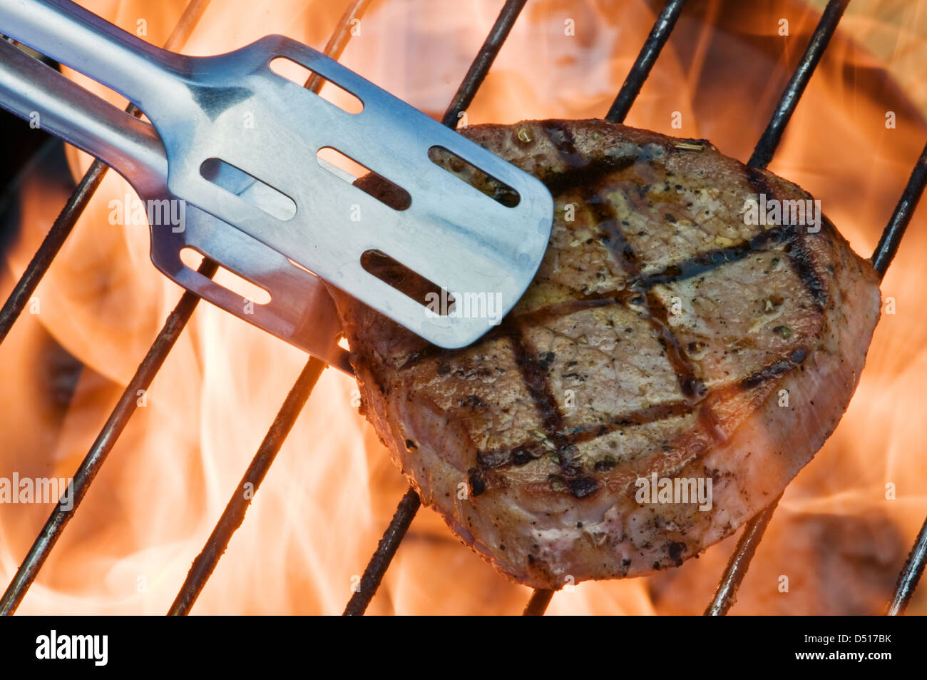 striped steak on fiery grill closeup Stock Photo