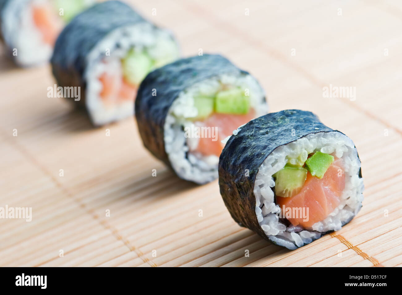 sushi in row on bamboo mat Stock Photo