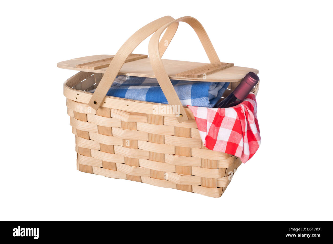 A new wicker picnic basket with a bottle of wine poking out the side Stock Photo