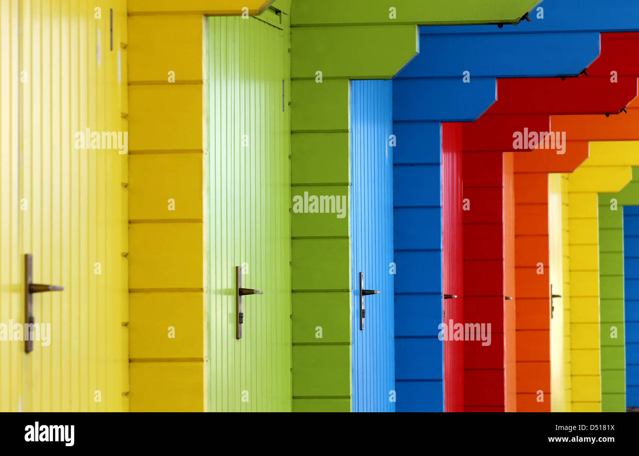 Row of colorful wooden beach chalet doors. Stock Photo