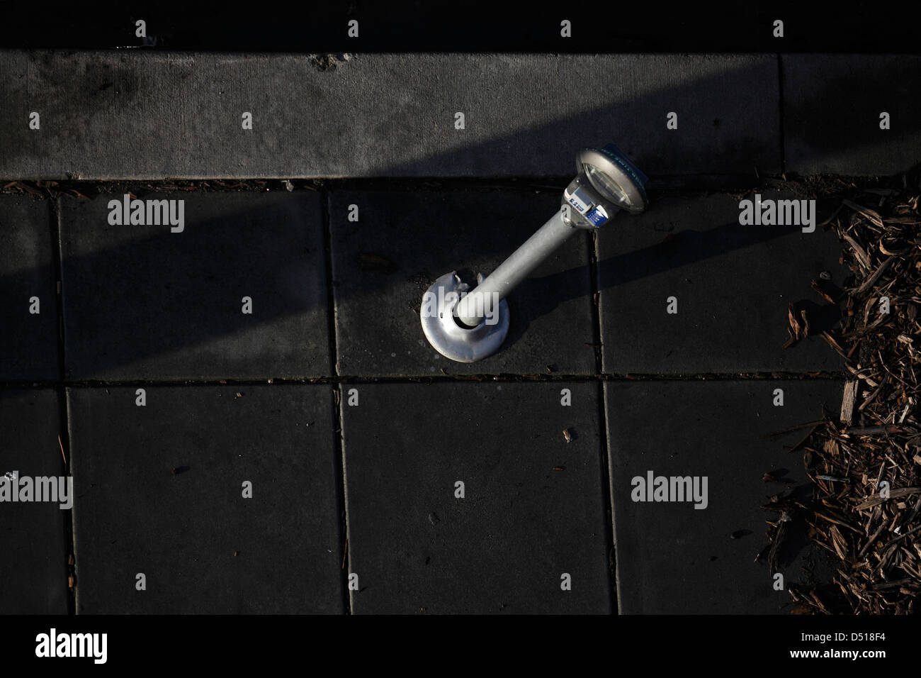 Parking meter on wet sidewalk. Stock Photo