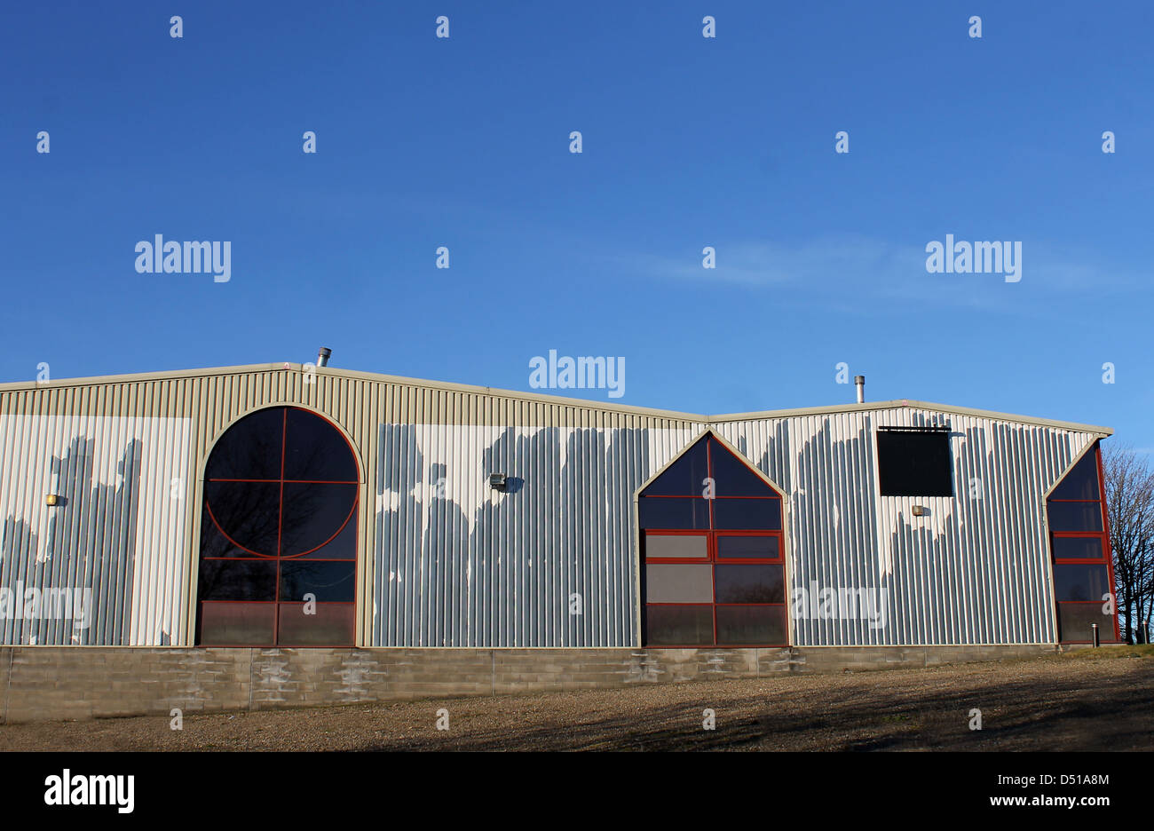 Exteror of old modern factory building with blue sky background. Stock Photo